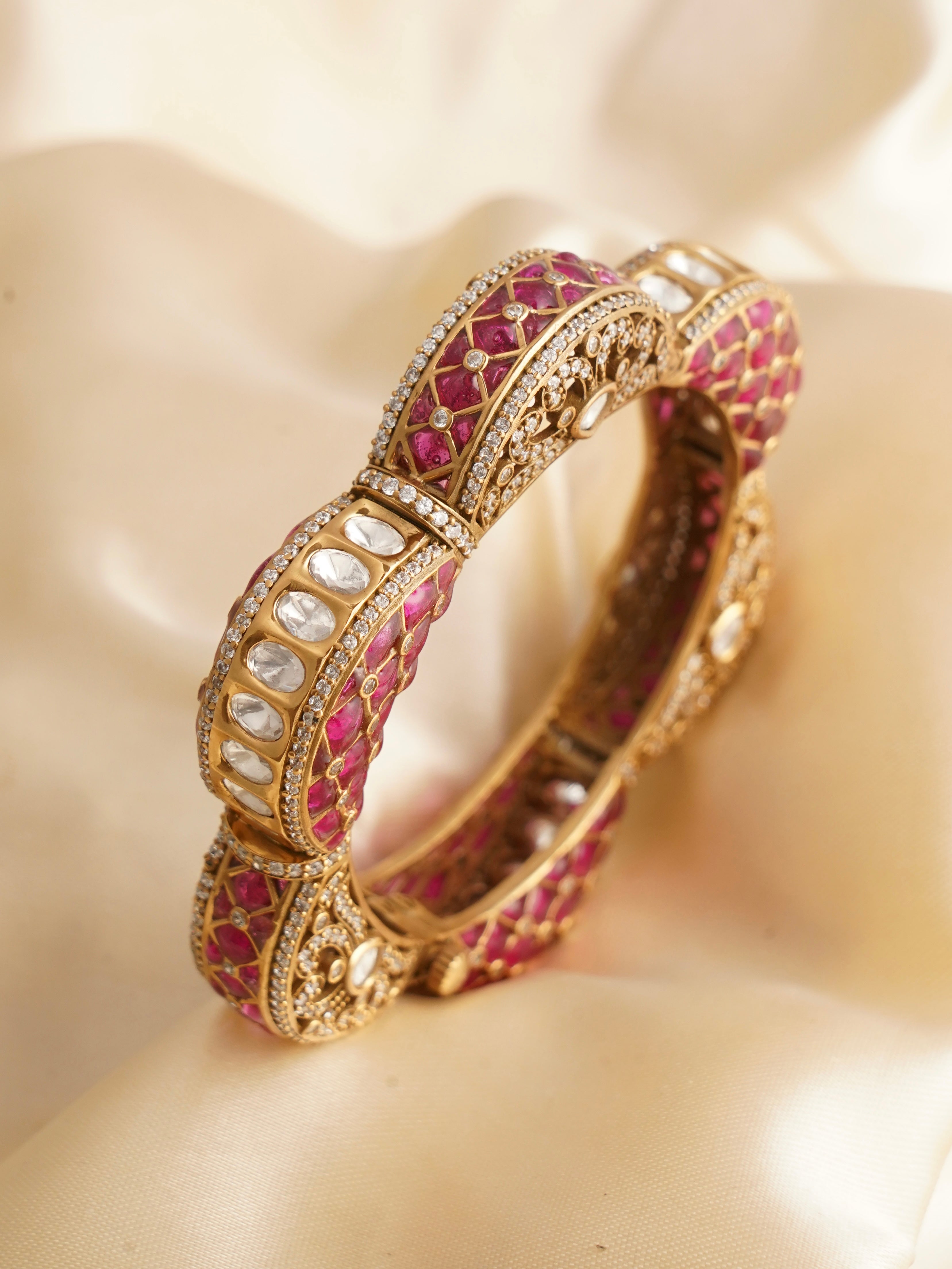 Close-up of openable floral kada with ruby, emerald, and kundan-style embellishments